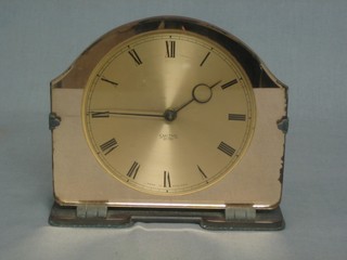 An Art Deco electric amber glass mantel clock contained in an arched case