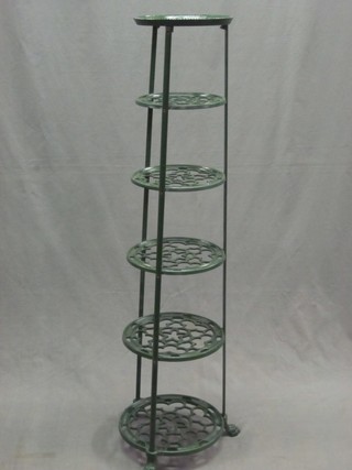 A green painted circular pierced metal 6 tier saucepan stand
