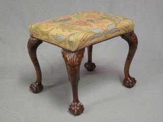 A rectangular walnut Queen Anne style stool raised on carved cabriole, ball and claw supports 21"