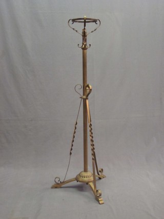 A Victorian brass adjustable oil lamp stand
