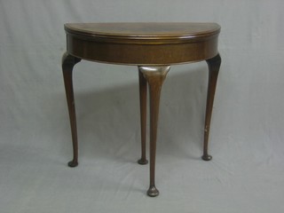 A 1930's Georgian style demi-lune card table raised on cabriole supports 29"