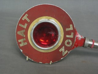 A West German traffic controller's electic halt sign and belt