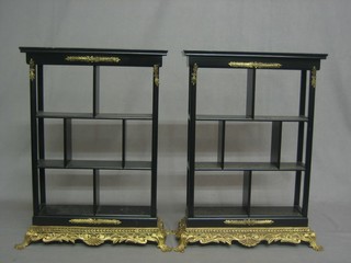 A pair of ebonised and gilt metal mounted display stands 13"