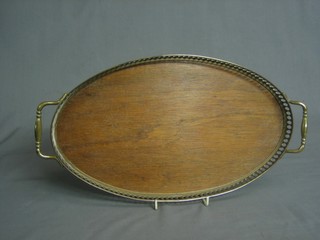 An oval oak and brass twin handled galleried tea tray 14"