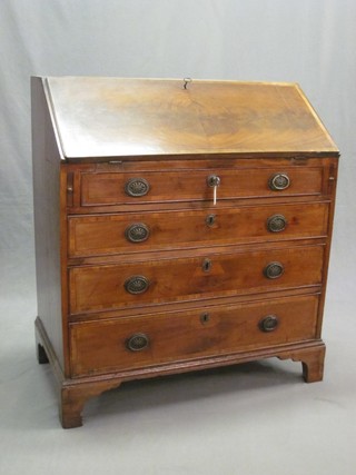 A Georgian mahogany bureau with cross banded decoration, the fall front revealing a fitted interior above 4 long graduated drawers, raised on bracket feet 33"