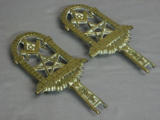 A pair of pierced brass flat irons decorated Mason symbols, the base marked FH&C