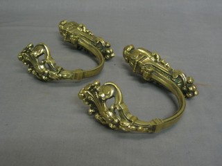 A pair of pierced brass curtain retainers