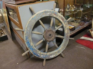 A circular wooden 8 spoked ships wheel 28"