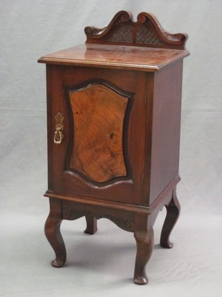 A Victorian walnut pot cupboard with raised back, the cupboard enclosed by a panelled door, raised on cabriole supports 15"
