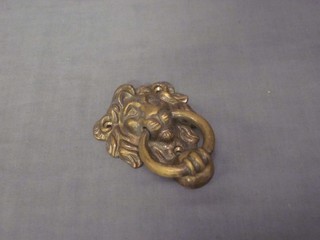 A brass lion mask door knocker 4" and a brass cantilever candle bracket