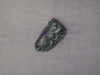 A section of carved green hardstone decorated a mythical beast 3"