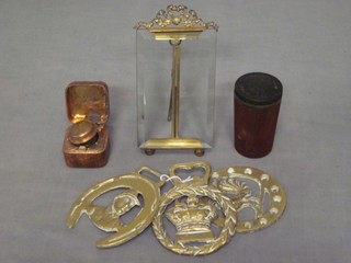 A rectangular gilt metal mounted photograph frame 4" x 2 1/2", 3 horse brasses and a brass and gilt metal inkwell