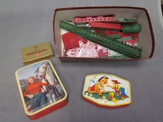 A collection of various green and red Meccano together with instructions for Outfit No.5