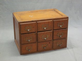 A Victorian honey oak table top index chest of 9 long drawers 24"