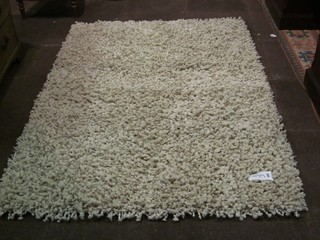 A contemporary beige ground deep pile wool rug 71" x 50"