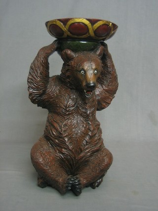 A resin figure of a seated bear supporting a dish 20"