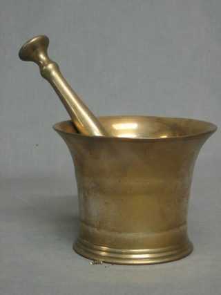 A brass bell shaped mortar and pestle 6"