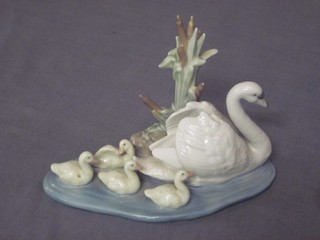 A Lladro figure of a swan with cygnets, base marked 55722
