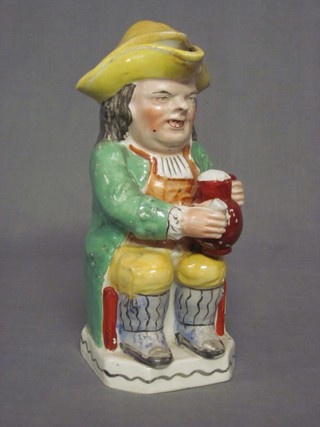 A 19th Century Staffordshire Toby jug in the form of seated Toby Philpot 10"