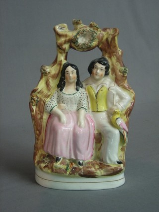 A 19th Century Staffordshire bird nest arbour group of a Lady and Gentleman 9"