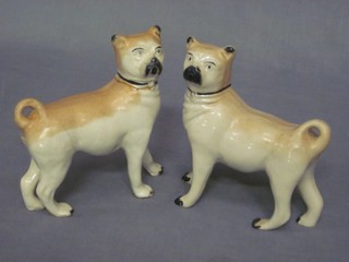 A pair of 19th Century Continental porcelain figures of standing Pugs 5" (1 cracked and head f and r)