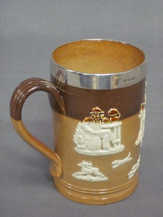 A cylindrical Royal Doulton stoneware tankard with silver band decorated hunting scenes, the base marked RD and impressed 1011
