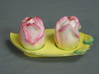A Royal Winton 2 piece condiment in the form of roses comprising salt and pepper pot, raised on an oval tray, the base with Gold Royal Winton mark (small area to base missing glaze)