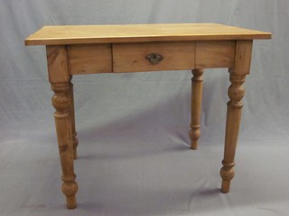 A Continental stripped and polished pine rectangular kitchen table, the base fitted a drawer, raised on turned supports 39"