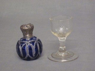 An antique wine glass raised on a spreading foot 3" and a blue overlay cut glass scent bottle with silver mounts (f)