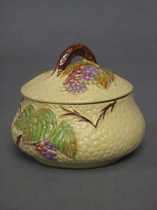 A circular Wade Burslem jar and cover decorated leaves and berries 3"