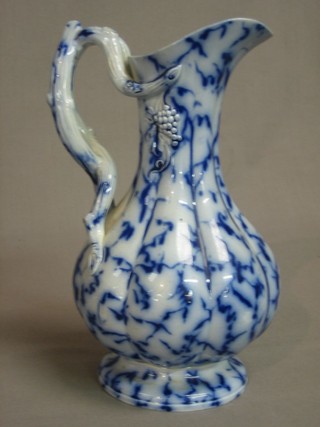 A 19th Century blue and floral glazed jug with crabstock handle 9"
