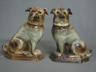 A pair of 19th Century pottery figures of seated Pugs with glass set eyes (1 eye missing, chips to base) 11"