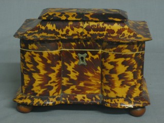 A handsome Victorian shaped tortoiseshell twin compartment tea caddy with hinged lid, raised on bun feet (slight chip to left hand edge and hinges) 7 1/2"