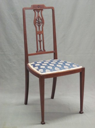 An Edwardian inlaid mahogany bedroom chair with pierced slat back and upholstered seat, raised on square tapering supports 