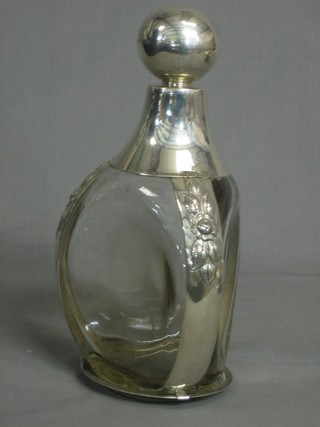 A glass dimple shaped bottle with silver mounts marked Sterling Mexico
