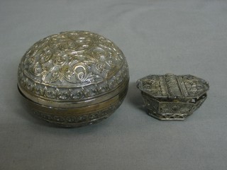 A silver filigree double sided basket 2" together with an Eastern embossed white metal jar and cover 3 ozs