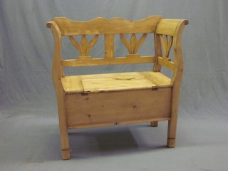 A Continental stripped and polished pine settle with pierced back 43"