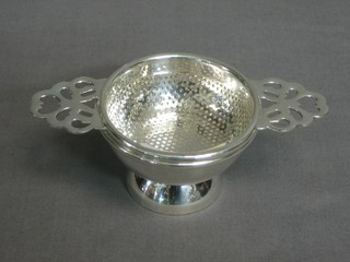 A modern silver plated tea strainer 