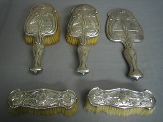 A handsome Art Nouveau  silver 5 piece dressing table set, the back embossed King Fishers amidst flowers, comprising pair of clothes brush, hair brush, hand mirror Chester 1903 RD 412167L and 1 matching hair brush Birmingham 1906