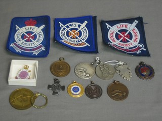 A silver watch chain medallion, 2 "silver" medals and a quantity of Royal Life Saving Society medals