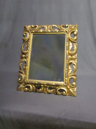 A rectangular plate mirror contained in a carved gilt wood frame  20" x 17"