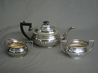 A 3 piece oval silver plated tea service with demi-reeded decoration by Mappin & Webb comprising teapot, twin handled sugar bowl and cream jug, inscribed