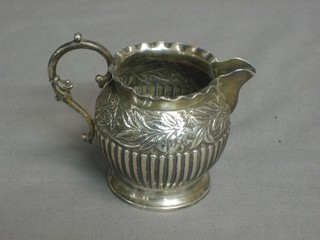 A Victorian silver cream jug with demi-reeded decoration, Birmingham 1888