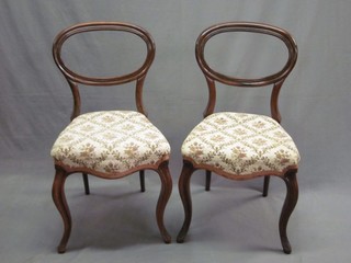 A set of 8 Victorian rosewood balloon back dining chairs, the seats of serpentine outline, raised on cabriole supports (1 with slight old worm to base, some damage)