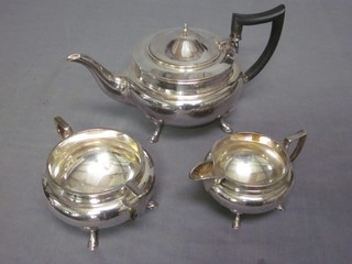 A circular silver plated 3 piece tea service comprising teapot, twin handled sugar bowl and cream jug