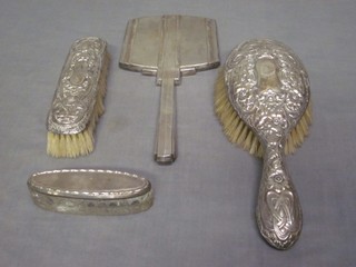 A silver backed hand mirror, do. clothes brush and hair brush, and a boat shaped cut glass jar with silver lid