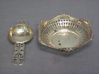 A  Continental silver tea strainer and a pierced white metal dish