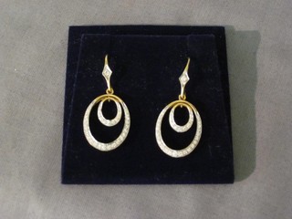A pair of 18ct pierced gold drop earrings set diamonds