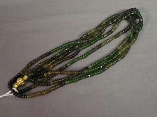 A 4 row multi coloured string of tourmaline beads with 14ct gold clasp
