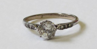 A lady's dress ring set a white stone